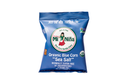 A 1.5 oz bag of Mi Niña Tortilla Organic Blue Corn “Sea Salt” Tortilla Chips—gluten free, no preservatives, non-GMO, organic, and 0g trans fat—all in blue packaging; available in a 24 pack.