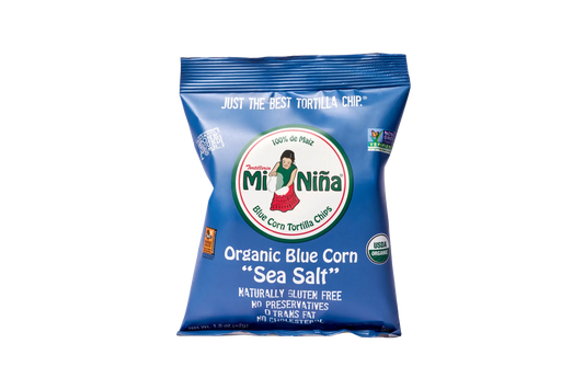 A 1.5 oz bag of Mi Niña Tortilla Organic Blue Corn “Sea Salt” Tortilla Chips—gluten free, no preservatives, non-GMO, organic, and 0g trans fat—all in blue packaging; available in a 24 pack.