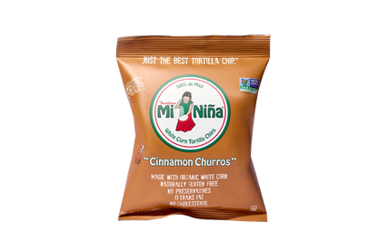 A brown Mi Niña Tortilla Cinnamon “Churros” Tortilla Chip 1.5 oz bag displays a girl in a red skirt logo and front details like no preservatives and no trans fat; available in a 24 pack.