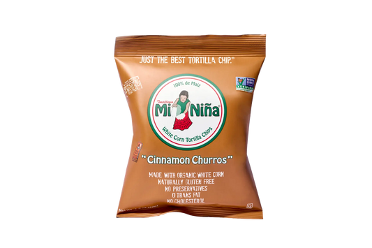 A brown Mi Niña Tortilla Cinnamon “Churros” Tortilla Chip 1.5 oz bag displays a girl in a red skirt logo and front details like no preservatives and no trans fat; available in a 24 pack.