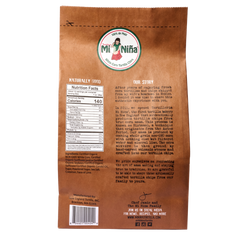 Back of a Mi Niña Tortilla Cinnamon “Churros” Chip 9 Pack bag, with the logo, nutrition facts, company story, and info—on a brown paper background inspired by their signature white corn tortilla chip.