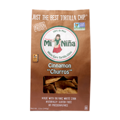 A brown Mi Niña Tortilla Cinnamon “Churros” Tortilla Chip bag (9 Pack / 12 oz) with a window showing the chips, labeled organic, gluten-free, and non-GMO.