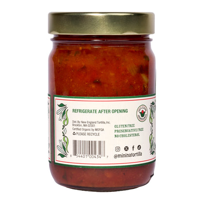 Mi Niña Tortilla Medium Tomato Salsa comes in a 6 pack of 12.8 oz glass jars. The label notes "Refrigerate After Opening," is gluten free, preservative free, and cholesterol free. Certification and recycling icons are shown.