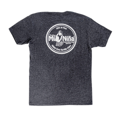 Unisex crew neck cotton t-shirt in heather gray featuring a circular white logo on the back with the text “Mi Niña, 100% de Maíz, Preservative Free, Stone Ground, Kettle Corn Tortilla Chips” and an image of a woman holding chips; by Mi Niña Tortilla.