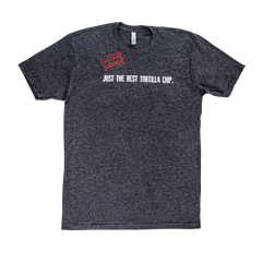 A Mi Niña Tortilla Unisex Crew Neck Cotton T-Shirt in dark gray, featuring white text that reads “Just the best tortilla chip.” and a red stamp-style “Siete Approved” graphic in the top left corner, shown laid flat against a plain white background.