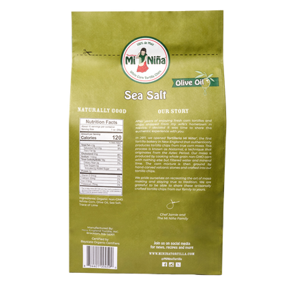 Back of a Mi Niña Tortilla Sea Salt Made with Olive Oil Tortilla Chip (9 Pack / 10 oz) bag, showing brand logo, nutrition facts, ingredients, company story, and social media info on a beige background.