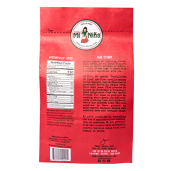The back of a red Mi Niña Tortilla Pico de Gallo Tortilla Chips – 12 oz Bags (9-Pack) snack bag featuring nutrition facts, an ingredient list, the company’s story, and a barcode.