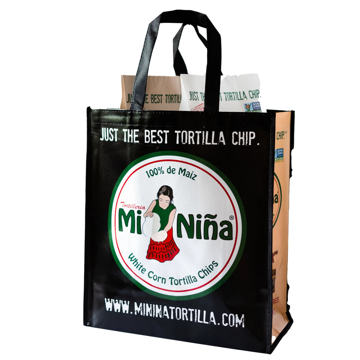 A black Reusable Tote Bag from Mi Niña Tortilla features a logo of a woman holding chips and is filled with brown paper tortilla chip bags. The text reads “Just the Best Tortilla Chip” along with the website www.mininatortilla.com.