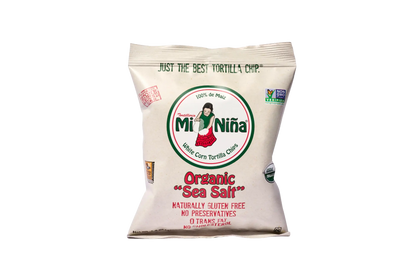 A bag of Mi Niña Tortilla Organic “Sea Salt” White Corn Tortilla Chips (1.5 oz, 24 Pack), gluten free, non-GMO, preservative-free, and made from white corn. Features a logo with a girl.