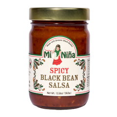 A 6 pack of Mi Niña Tortilla Spicy Black Bean Salsa, 12.8 oz jars with gold lids, each featuring a woman in traditional dress, green and red text, and decorative designs.