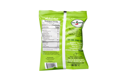Back of a green 1.5 oz Mi Niña Tortilla “Spicy Chipotle Lime” chip bag features nutrition facts, flavor list, brand story, barcode, and social media info. Text and graphics are black and white. Sold as a 24 pack.