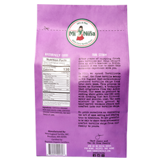 Back of a Mi Niña Tortilla Organic Thin & Crispy Sea Salt Tortilla Chip 10 oz bag showing nutrition facts, ingredients, brand logo, product story, certifications, and social media info in black and white text.