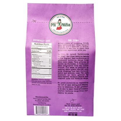Back of a Mi Niña Tortilla Organic Thin & Crispy Sea Salt Tortilla Chip 10 oz bag showing nutrition facts, ingredients, brand logo, product story, certifications, and social media info in black and white text.