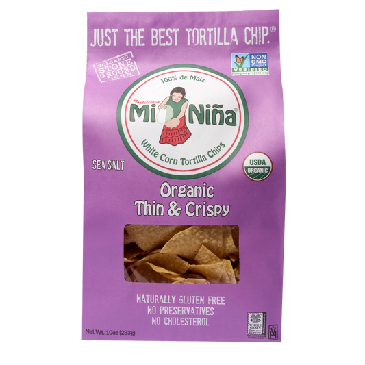A 10 oz bag of Mi Niña Tortilla Organic Thin & Crispy Sea Salt Tortilla Chips comes in purple packaging with USDA Organic, Non-GMO, and gluten free labels, letting you see the crispy chips inside.